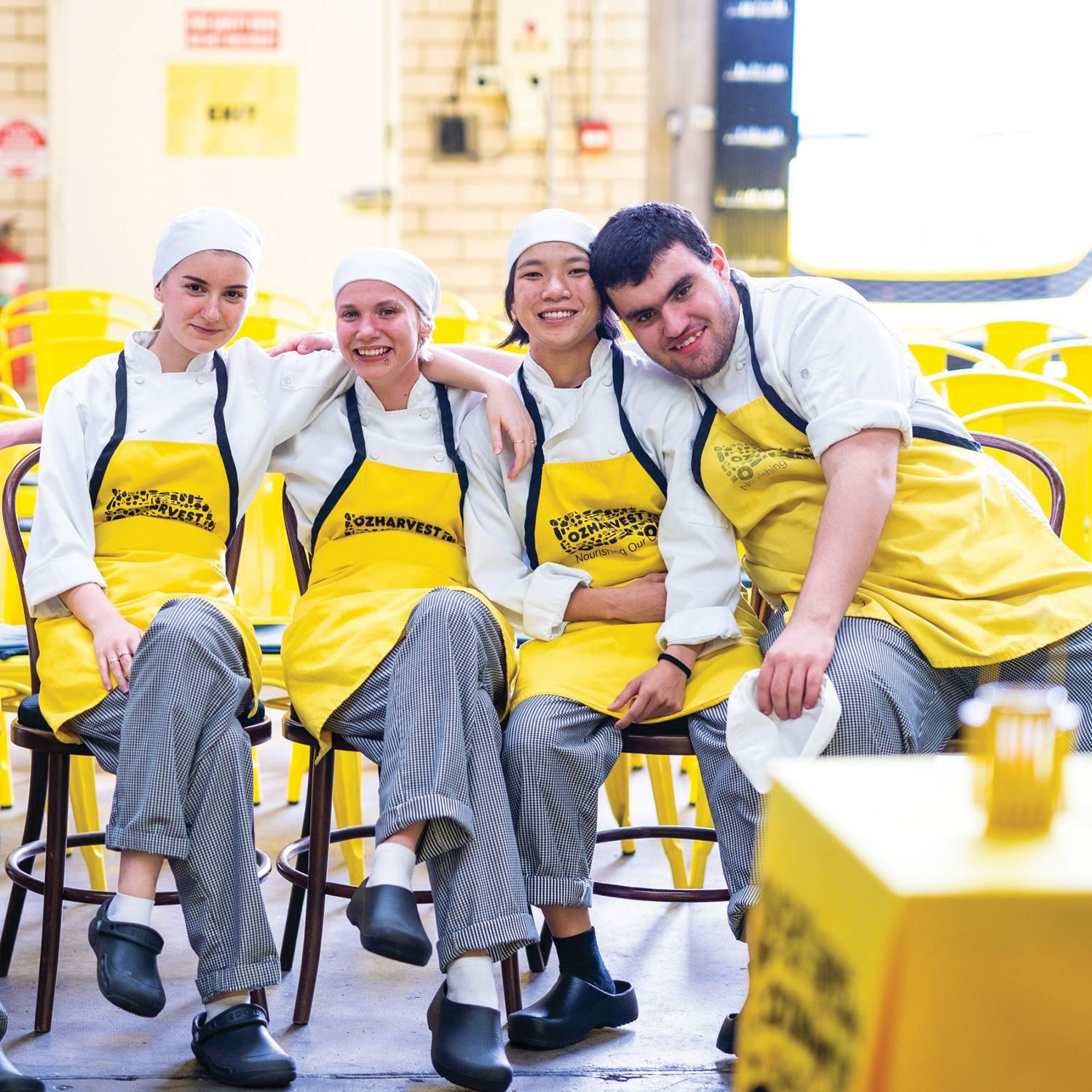 A. group of people all wearing ozharvest aprons